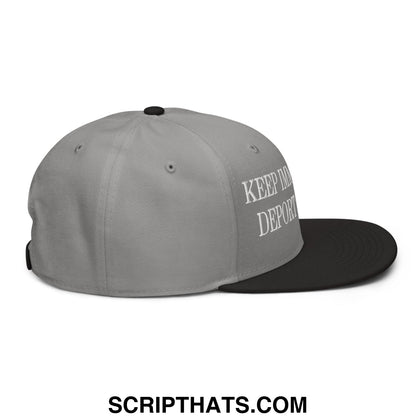 Gray and black snapback hat with white embroidered keep in deport text on the side for immigrant rights activism