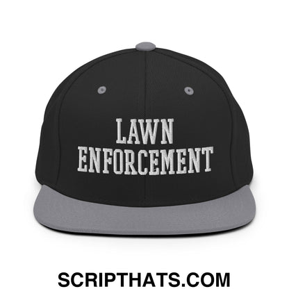 Black snapback cap with gray flat bill and white embroidered lawn enforcement text in bold collegiate font