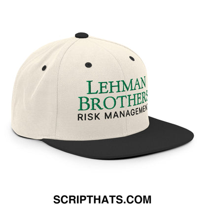 Cream-colored snapback hat with black flat brim and green embroidered Lehman Brothers risk management text
