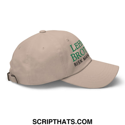 Beige unstructured dad hat with green embroidered lehman brothers risk management text on the front