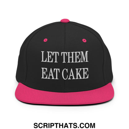 Black snapback cap with pink brim and white embroidered let them eat cake text on front panel