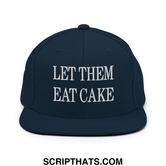 Navy blue snapback cap with white embroidered let them eat cake text and flat bill brim design