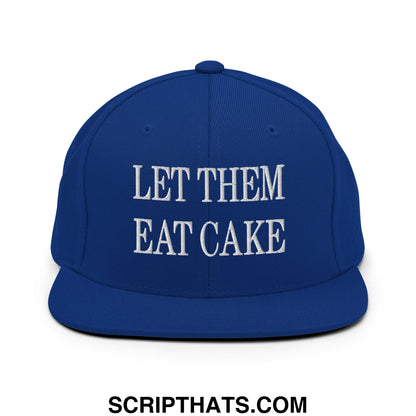 Royal blue snapback hat with white embroidered let them eat cake text and flat bill brim design