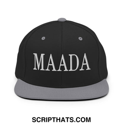 Black snapback cap with gray brim featuring white embroidered Maada lettering in classic serif font, flat bill design
