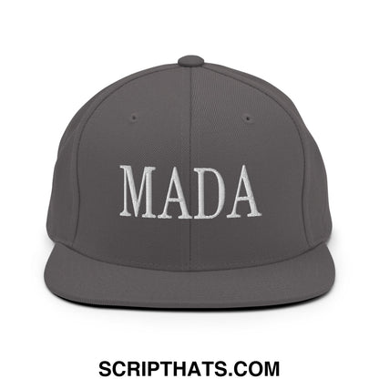 A dark gray snapback hat with mada embroidered in white thread on the front flat bill brim