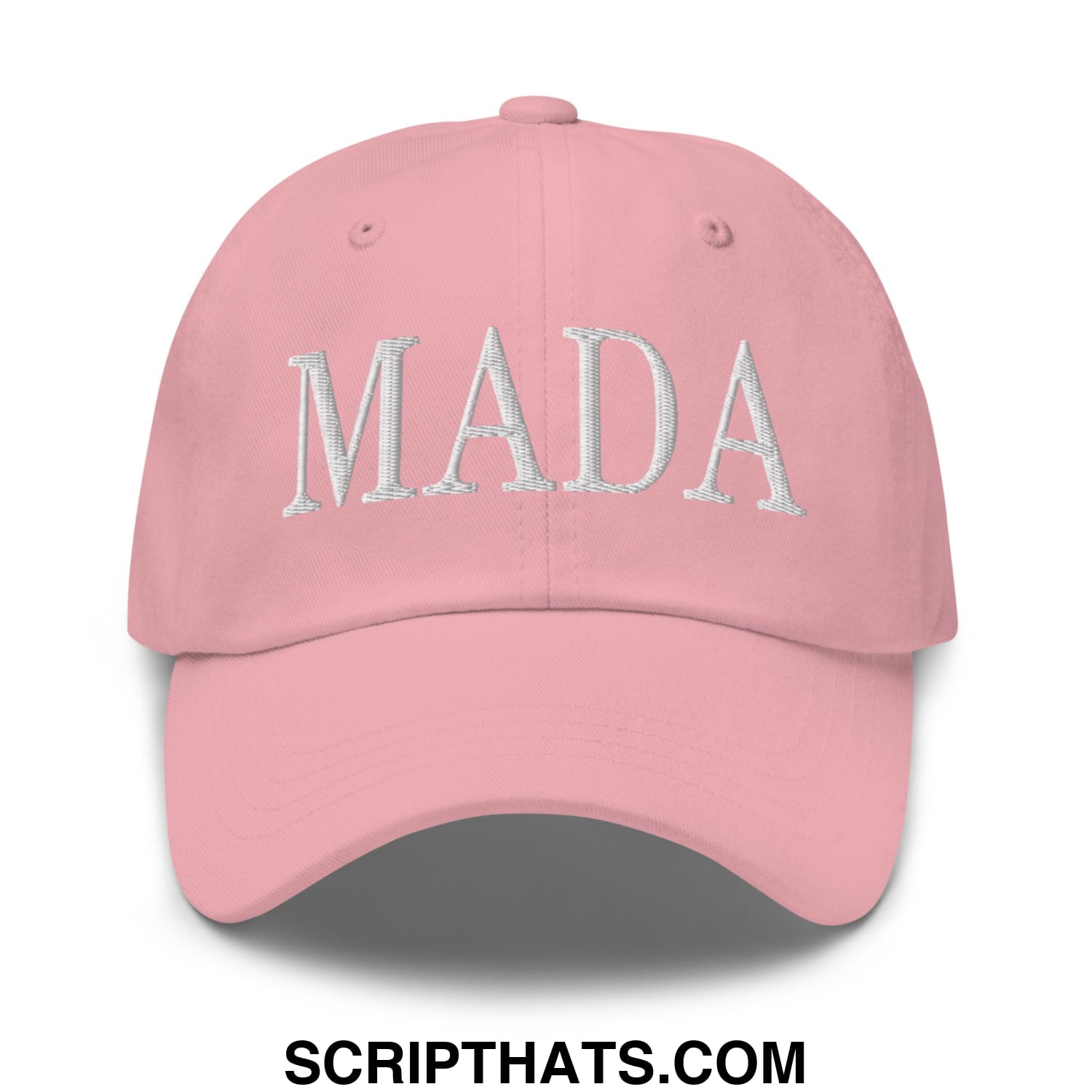 A soft pink unstructured baseball dad hat with mada embroidered in white thread across the front