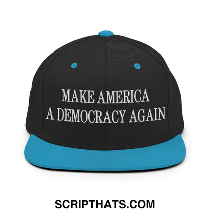 Black snapback cap with teal brim and button featuring white embroidered make america a democracy again text