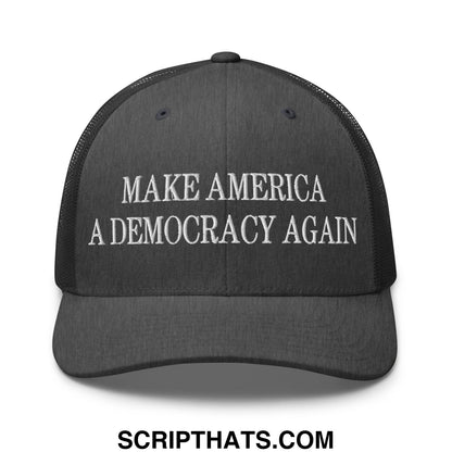 Black mesh trucker hat with white embroidered text make America a democracy again across the front panel