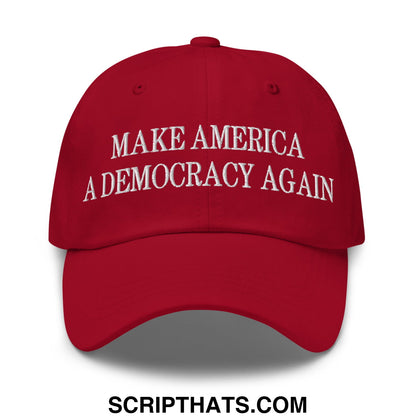 Red unstructured dad hat with white embroidered text make america a democracy again for casual wear