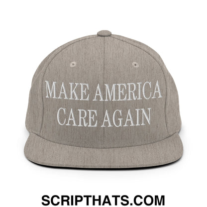 Gray snapback hat with white embroidered make america care again text and flat bill brim design