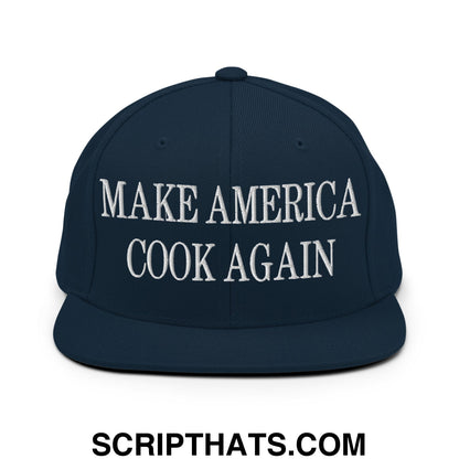 Navy blue snapback hat with white embroidered make america cook again text and flat bill brim design