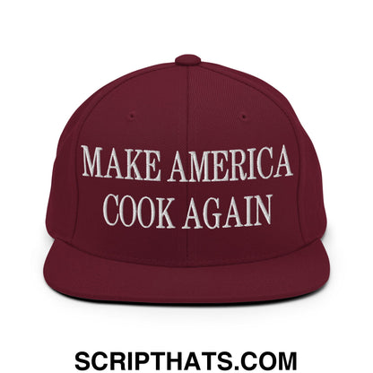 Maroon snapback hat with white embroidered make america cook again text and flat bill brim design
