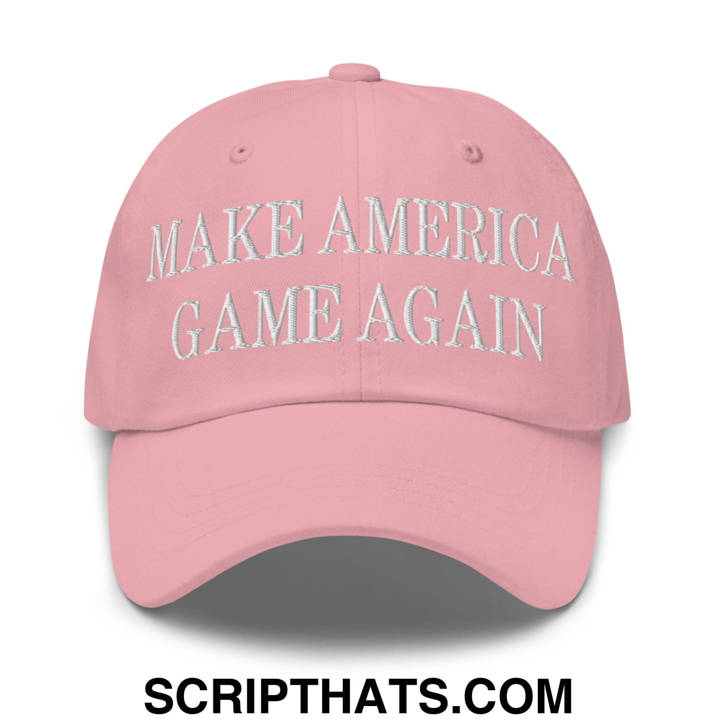 A soft pink unstructured dad hat with make america game again embroidered in white thread across the front