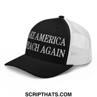 Black and white mesh trucker hat with make america peach again embroidered in bold raised lettering on the front panel