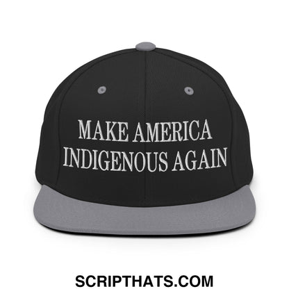Black snapback hat with gray brim and white embroidered make america indigenous again text on front panel