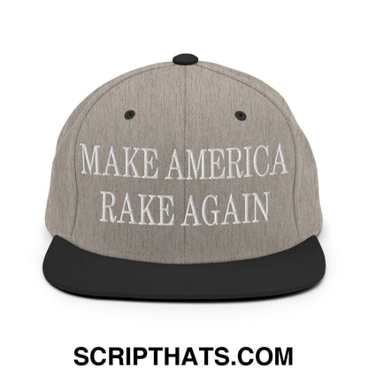 Gray snapback hat with black flat bill brim and embroidered white text make america rake again