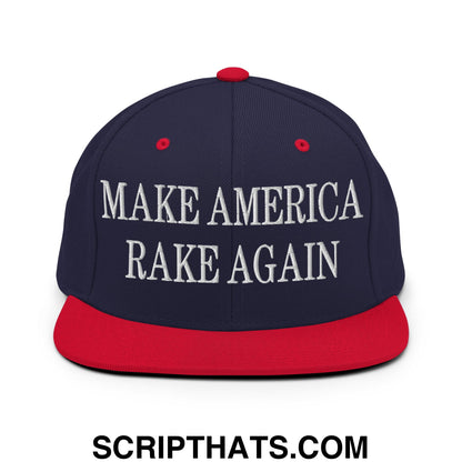 Navy blue and red snapback cap with white embroidered make america rake again text and flat bill brim