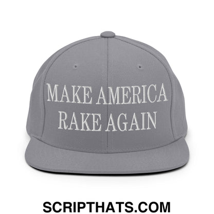 Gray snapback hat with white embroidered make america rake again text featuring a flat bill brim design