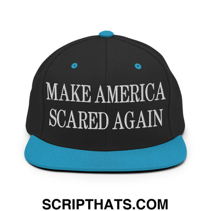 Black snapback cap with teal brim and button featuring white embroidered text make america scared again