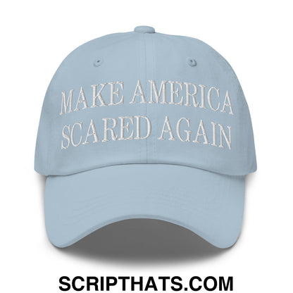 Light blue unstructured dad hat with white embroidered text make america scared again on front panel