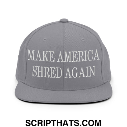 Gray snapback cap with white embroidered make america shred again text featuring a flat bill brim design