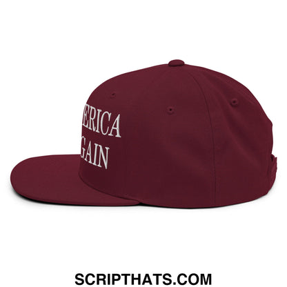 Maroon snapback cap with white embroidered america again text and flat bill brim by Make America Woke Again