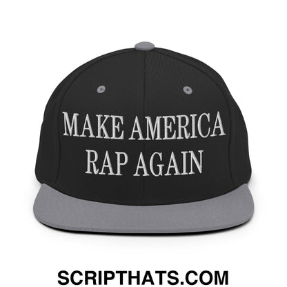 Black snapback cap with gray brim and button featuring white embroidered make america rap again text