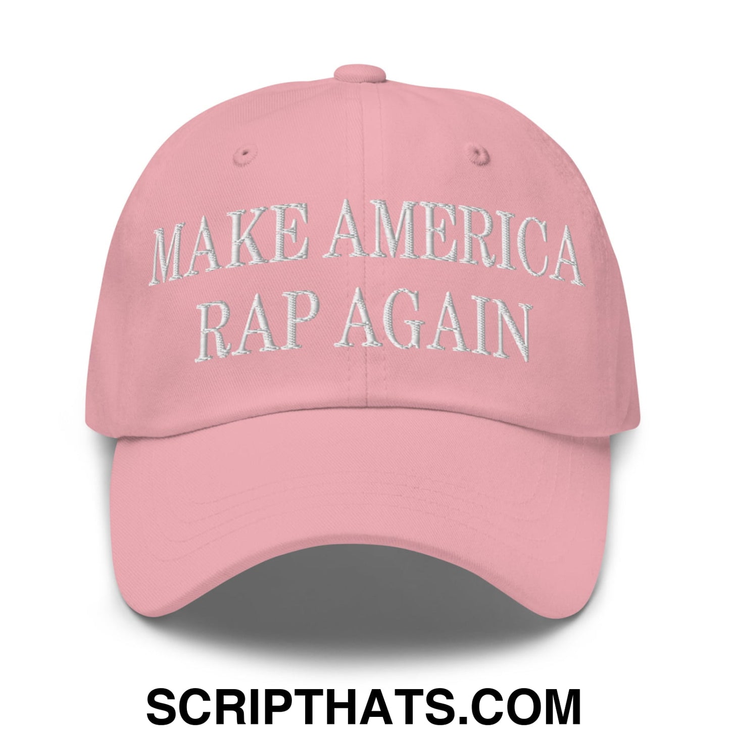 A soft pink unstructured dad hat with make america rap again embroidered in white thread across the front