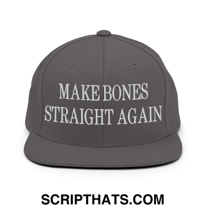 A dark gray snapback hat with white embroidered make bones straight again text on the front flat bill brim