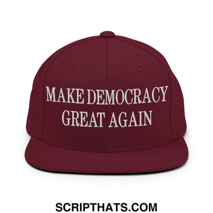 Maroon snapback hat with flat bill brim and white embroidered make democracy great again text