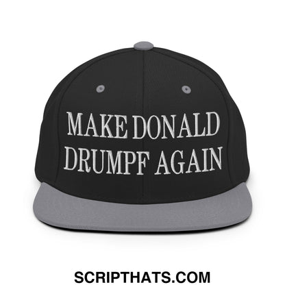 Black snapback cap with gray flat bill brim featuring white embroidered text make Donald Drumpf again