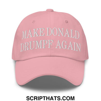 A soft pink unstructured dad hat with white embroidered text make donald drumpf again on the front