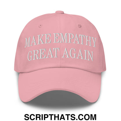 A soft pink unstructured dad hat with white embroidered text reading make empathy great again