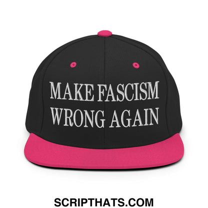 Black snapback cap with vibrant pink brim and button featuring white embroidered make fascism wrong again text