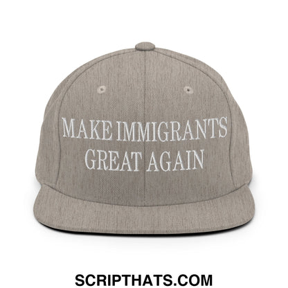 Gray snapback cap with white embroidered text reading make immigrants great again and a flat bill brim