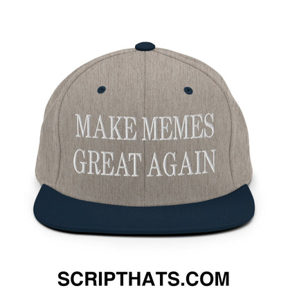 A gray and navy blue snapback hat with white embroidered make memes great again text and a flat bill brim