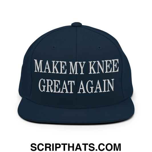 Navy blue snapback hat with white embroidered text make my knee great again and flat bill brim design