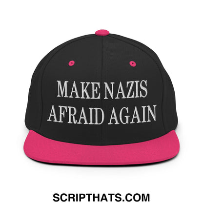 Black snapback hat with pink brim and button featuring white embroidered text make nazis afraid again