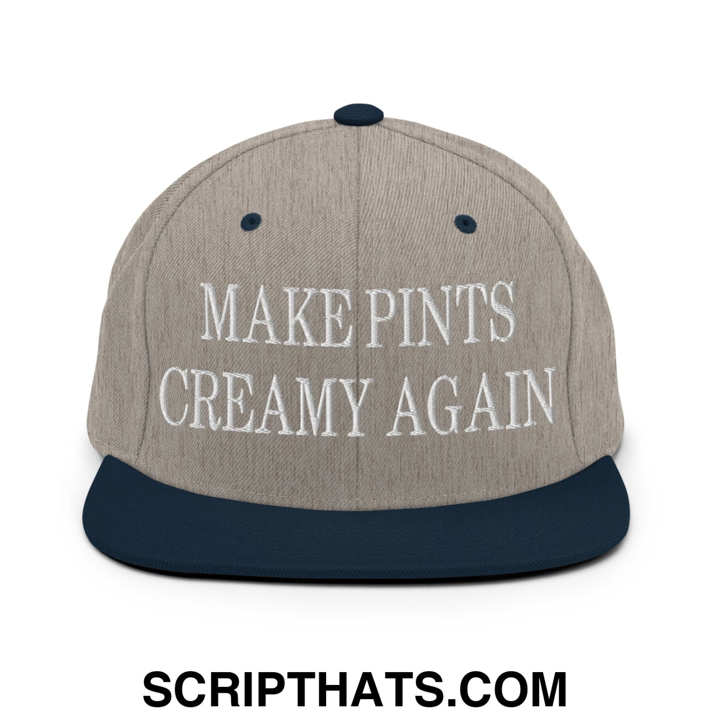 A gray and navy blue snapback hat with white embroidered make pints creamy again text and a flat bill brim