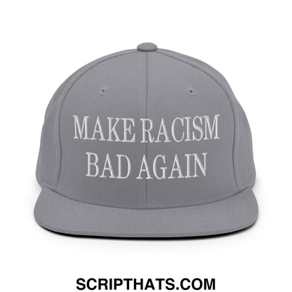 Gray snapback hat with white embroidered text reading make racism bad again and a flat bill brim design