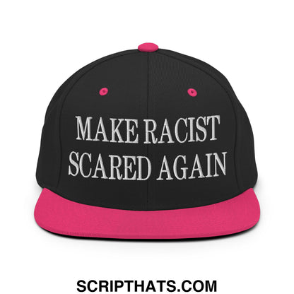Black snapback hat with vibrant pink flat bill and button featuring white embroidered make racist scared again text