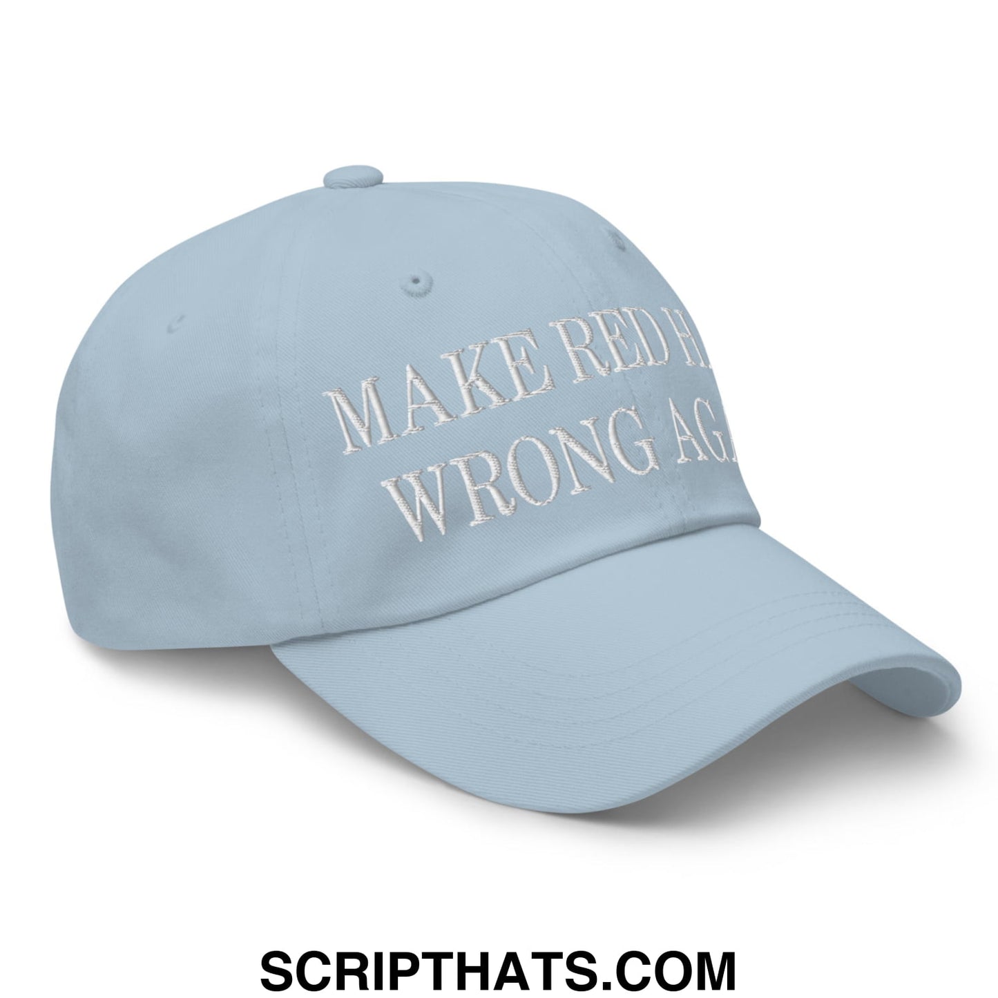 Light blue unstructured dad hat with white embroidered make red hats wrong again text on front panel