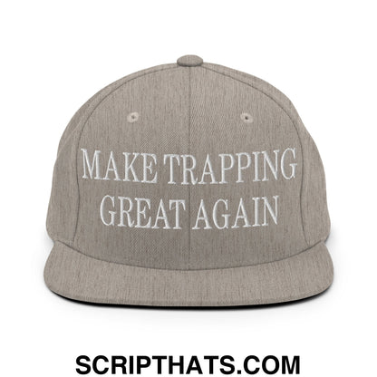 A gray snapback hat with white embroidered make trapping great again text and a flat bill brim