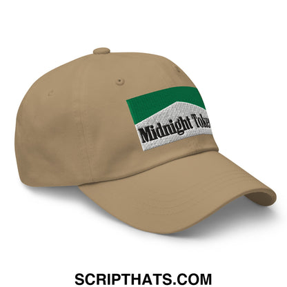 Tan unstructured dad hat with green and white embroidered patch reading midnight token in black lettering