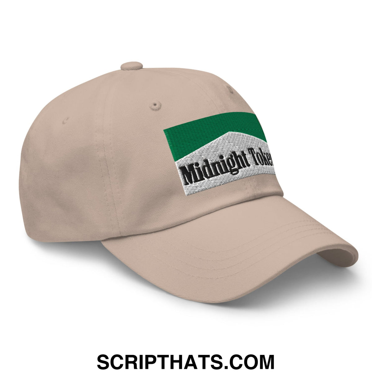 Beige unstructured dad hat with green and white embroidered midnight token patch featuring black lettering