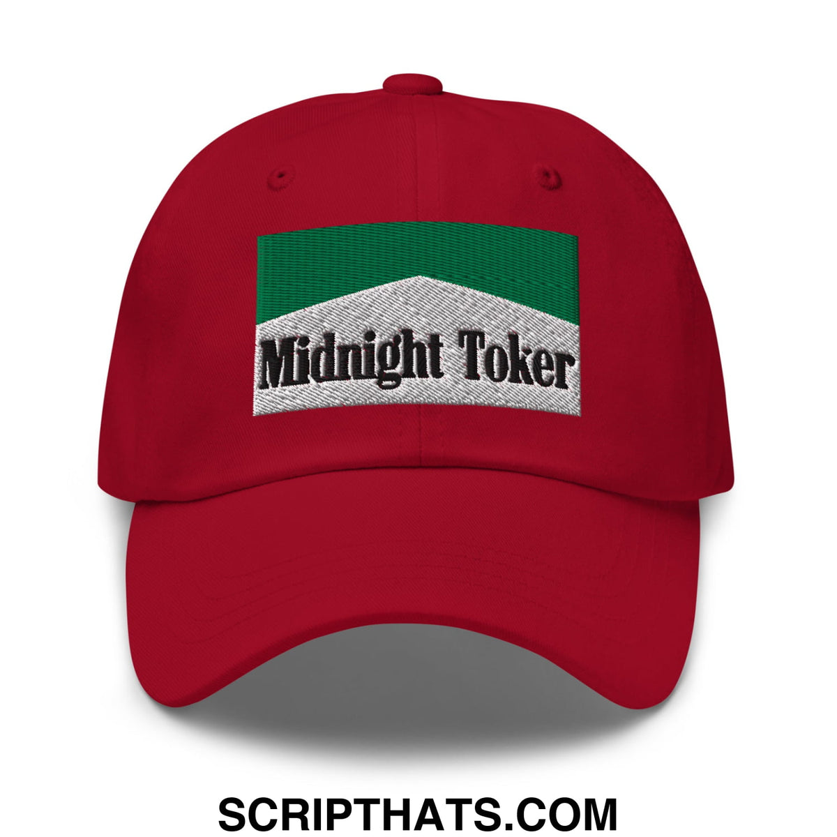 Red unstructured dad hat featuring a green and white embroidered patch with midnight toker text in black lettering