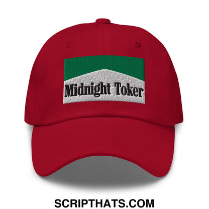 Red unstructured dad hat featuring a green and white embroidered patch with midnight toker text in black lettering