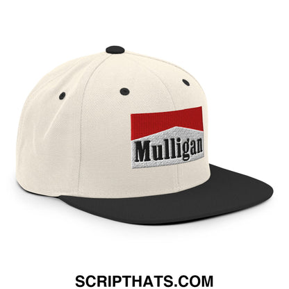Cream-colored snapback cap with black flat bill and red white black embroidered Mulligan cigarette logo