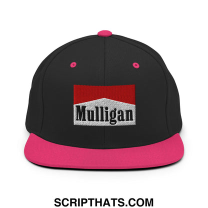 Black snapback cap with vibrant pink flat bill brim button and black embroidered mulligan logo on white textured background