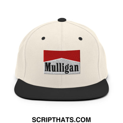 Cream-colored snapback hat with black flat bill and red white black embroidered mulligan logo design